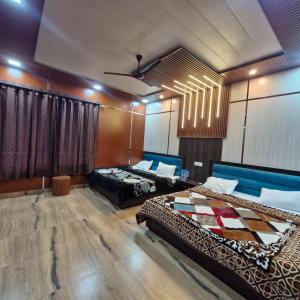 a room with two beds and a blue couch at Inder's Heritage in Bangīna