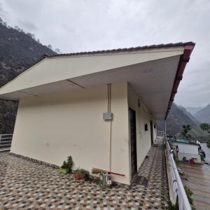 a large white building with a roof at Inder's Heritage in Bangīna