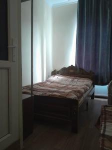 a bedroom with a bed with a wooden frame at ლაზები in Akhaltsikhe