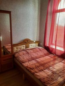 a bedroom with a bed next to a window at ლაზები in Akhaltsikhe