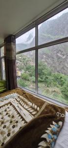 a bed in a room with a large window at Inder's Heritage in Bangīna