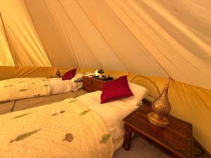 a bedroom with two beds in a tent at Slane Concert - Riverside Glamping in Navan
