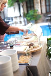 a woman standing at a table with a tray of food at La Paloma Hotel in Antalya