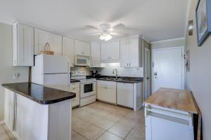 a kitchen with white appliances and a ceiling fan at Beachwood Place 3E in Hilton Head Island