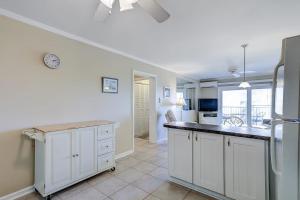 a kitchen with white cabinets and a counter top at Beachwood Place 3E in Hilton Head Island +20 photos