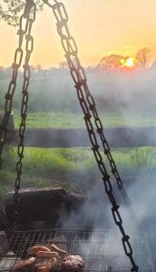 a chain hanging over a grill with food on it at Slane Concert - Riverside Glamping in Navan