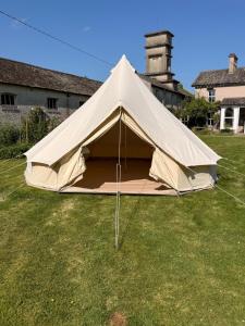 a large tan tent in a field of grass at Slane Concert - Riverside Glamping in Navan