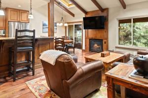 a living room with a couch and a fireplace at Seasons Four #178 in Snowmass Village