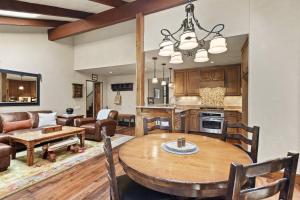 a kitchen and living room with a wooden table at Seasons Four #178 in Snowmass Village