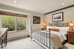 a bedroom with a bed and a large window at Seasons Four #178 in Snowmass Village