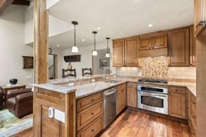a kitchen with wooden cabinets and a counter top at Seasons Four #178 in Snowmass Village +33 photos