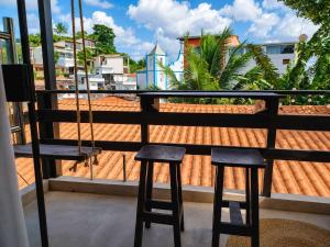 a balcony with two chairs and a swing at Morro de São Paulo - Boho Loft Escape Pool Balcony & Champagne in Cairu