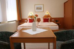 Postel nebo postele na pokoji v ubytování Hotel Petersen