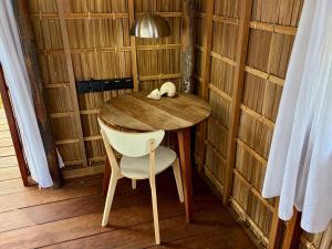 a small table and a chair in a room at ipyum Premium Beach Guest House in Sageurin +7 photos