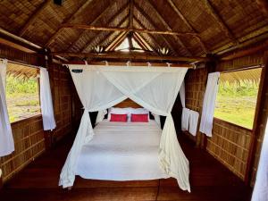 a bed in the back of a tent at ipyum Premium Beach Guest House in Sageurin