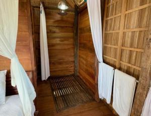 a room with a bed and chairs in a cabin at ipyum Premium Beach Guest House in Sageurin