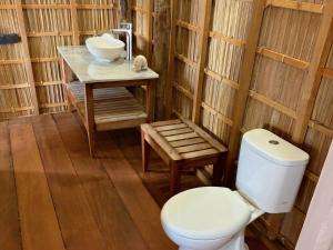 a bathroom with a toilet and a sink at ipyum Premium Beach Guest House in Sageurin