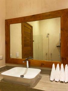 a bathroom with a sink and a large mirror at MAJO Hotel Boutique in Holbox Island +49 photos