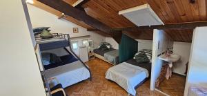 a small room with two bunk beds and a sink at AMCP Gîte - Montgiscard in Montgiscard +33 photos