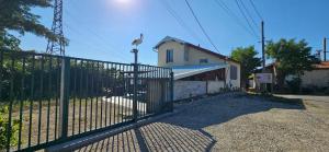 a fence with a gate in front of a house at AMCP Gîte - Montgiscard in Montgiscard