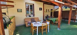 a room with a table and chairs and a table and a couch at AMCP Gîte - Montgiscard in Montgiscard