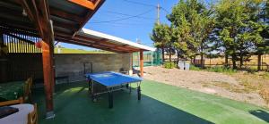 a blue ping pong table on a patio at AMCP Gîte - Montgiscard in Montgiscard