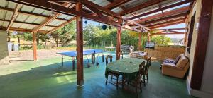 a patio with a ping pong table and chairs at AMCP Gîte - Montgiscard in Montgiscard