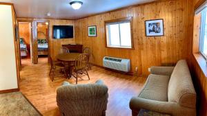a living room with a couch and a table and chairs at Benzonia Rustic Resort in Benzonia