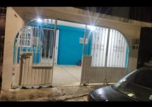a blue door of a house with a blue garage at Casa naranjito in Cosoleacaque
