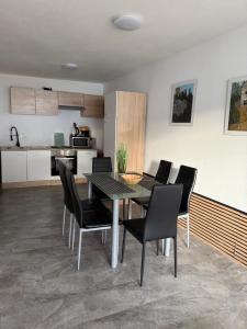 a kitchen and dining room with a table and chairs at Apartment Oberleins II in Arzl im Pitztal