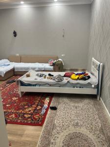 a small room with a bed and a rug at Luxury Tashkent house Zenith in Tashkent