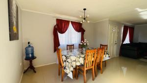 a dining room with a table and chairs and a window at Casa campo Quillota in Quillota +5 photos