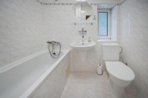 a white bathroom with a toilet and a sink at Penzion Sv. Duch in Český Krumlov +43 photos