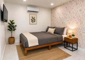 a bedroom with a bed and a plant and a tv at 05 Modern Co-Living Home with Newly Renovated Private Rooms Available in Miami