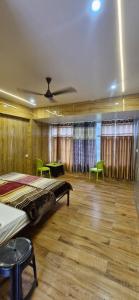 a bedroom with two beds and a table and chairs at Inder's Heritage in Bangīna