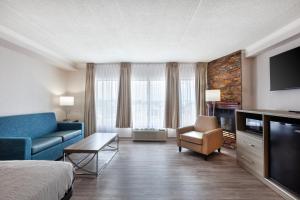 a hotel room with a bed and a couch and a tv at Quality Inn & Suites in Niagara Falls