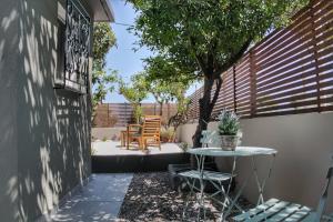 a patio with a table and chairs and a tree at Casa Katrine in Lakíthra