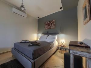 a bedroom with a large bed and a table at Casa Katrine in Lakíthra