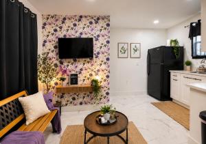 a living room with a couch and a tv on a wall at 05 Modern Co-Living Home with Newly Renovated Private Rooms Available in Miami