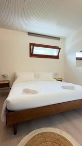 a bedroom with a large bed with a window at Riflesso Apartment in Blevio