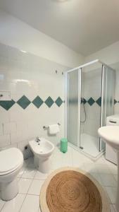 a bathroom with a toilet a sink and a shower at Riflesso Apartment in Blevio +13 photos