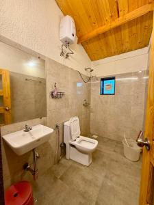 a bathroom with a toilet and a sink at Harmals Studios & Apartments in Arambol +32 photos