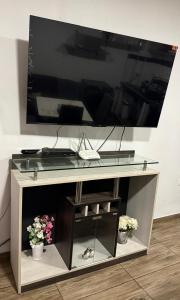 a table with a television on top of it at Comodidad en un solo lugar in Lima
