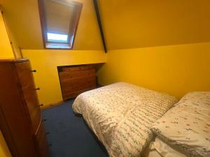 a bedroom with a bed and a dresser and a window at Athenry Stay in Athenry +1 photo