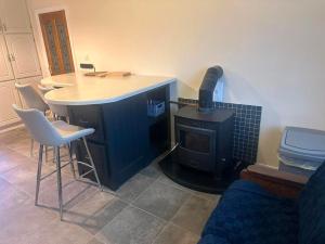 a kitchen with a stove and a table and chairs at Athenry Stay in Athenry