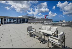a cruise ship in the ocean with chairs at Harbour House apt 410 in Oranjestad
