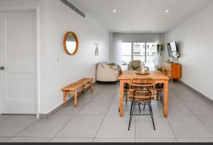 a living room with a wooden table and chairs at Harbour House apt 410 in Oranjestad