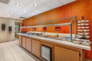 a restaurant kitchen with a counter with food at Best Western Plus Scottsdale Thunderbird Suites in Scottsdale