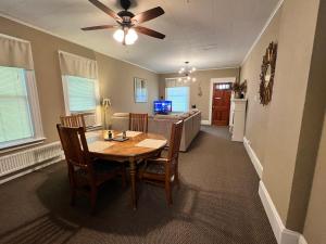 a dining room and living room with a table and chairs at Great Gorge Guesthouse - Walk to the Falls, the Casino and all Downtown Restaurants - Across from the Aquarium in Niagara Falls