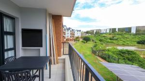 a balcony with a table and a view of a street at Ballito Hill's Serenity Suite in Ballito